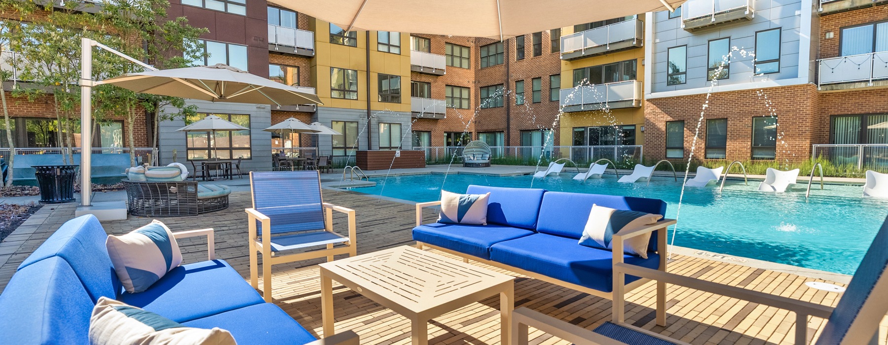 sparkling, outdoor pool with water features and poolside eating areas