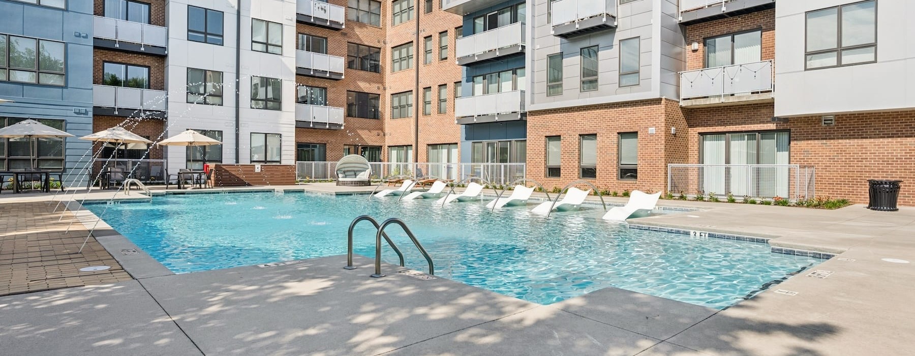 pool area with reclining seats and landscaping